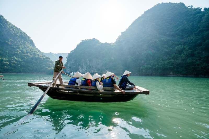 Experience a serene bamboo rowboat tour on Rita Cruise, surrounded by lush greenery. Book now!